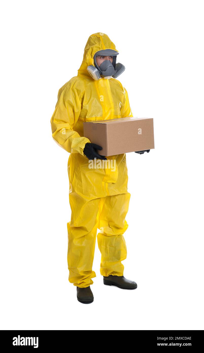Man wearing chemical protective suit with cardboard box on white background. Prevention of virus spread Stock Photo