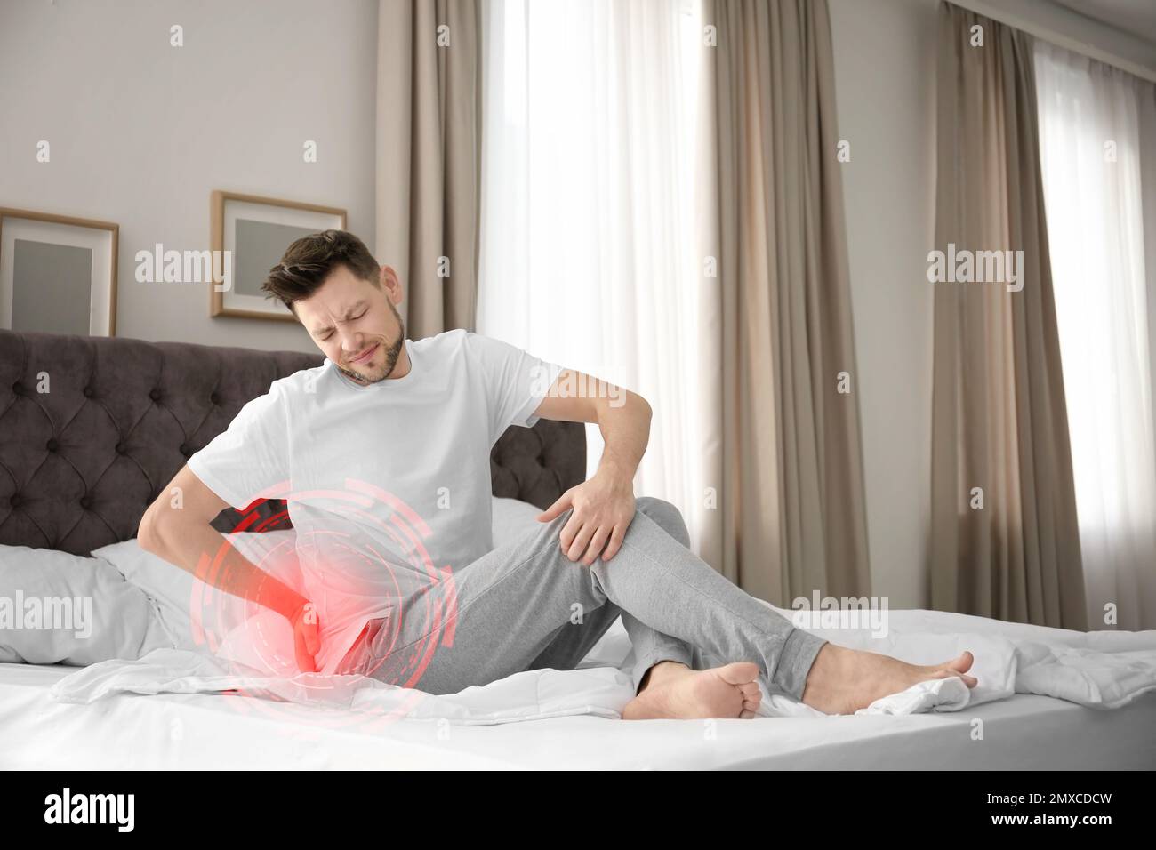 Man suffering from back pain after sleeping on mattress