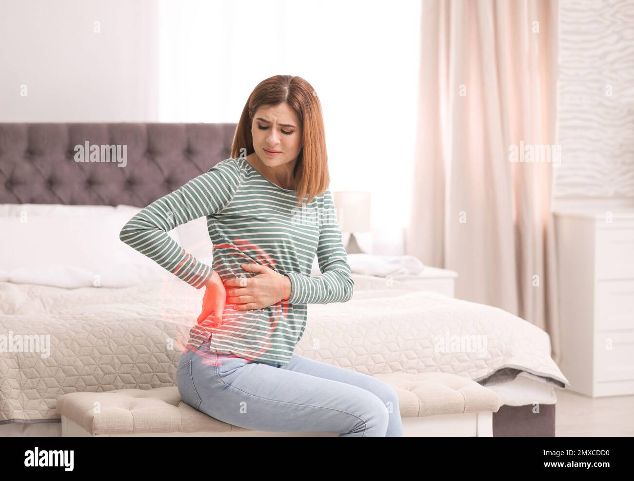 Woman suffering from back pain after sleeping on mattress