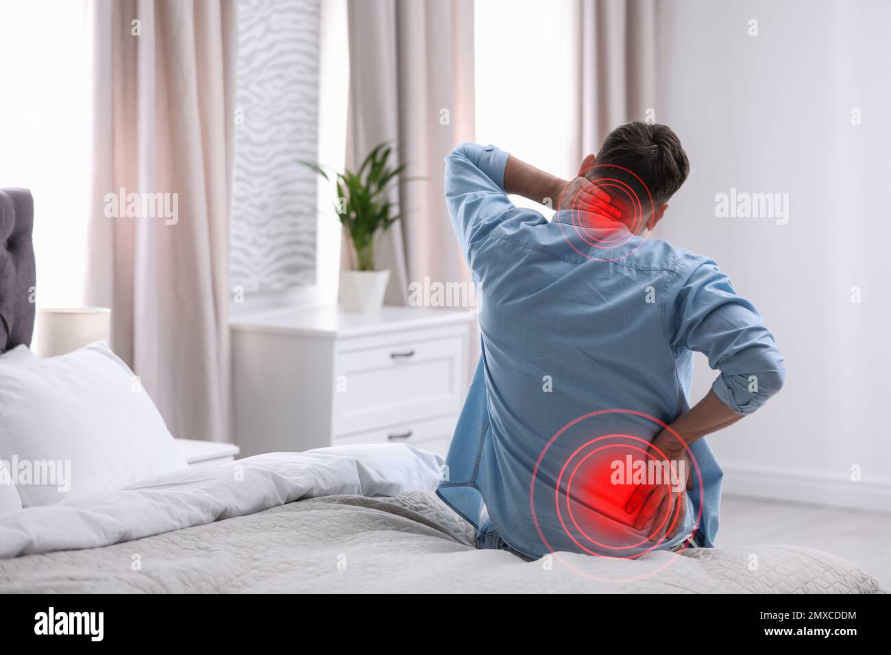 Man suffering from back pain after sleeping on mattress