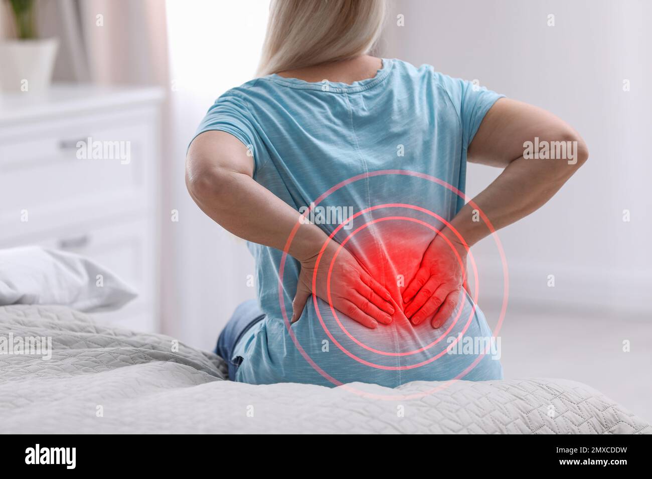 Senior woman suffering from back pain after sleeping on