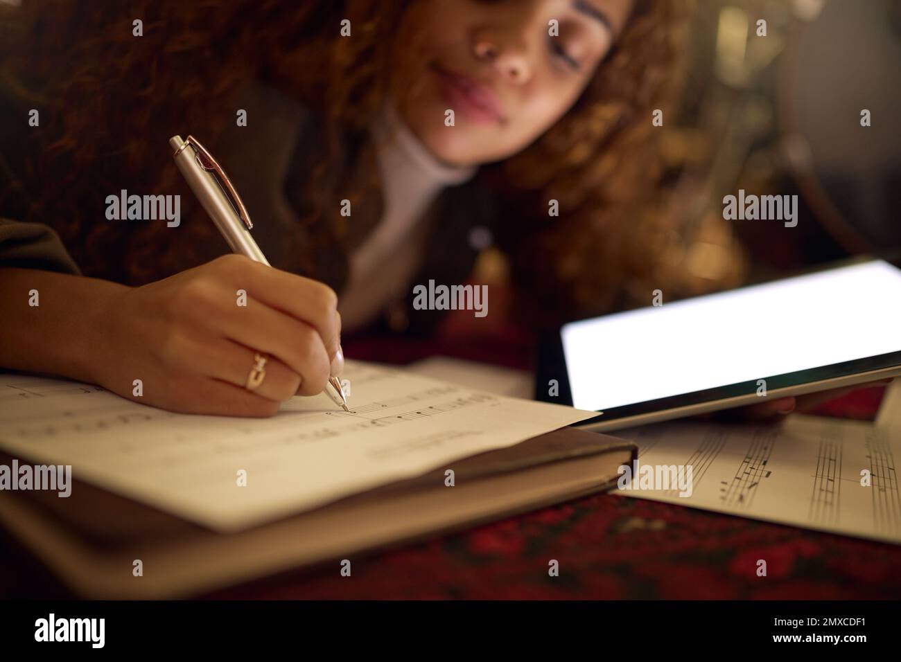Tablet, paper and black woman writing music notes for song lyrics