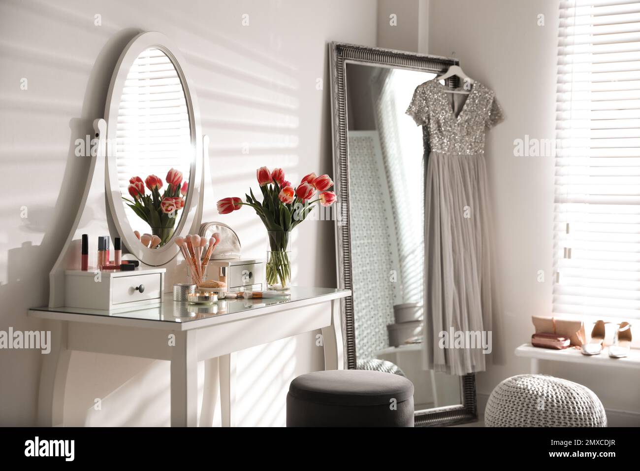 Stylish room interior with elegant dressing table and mirror Stock
