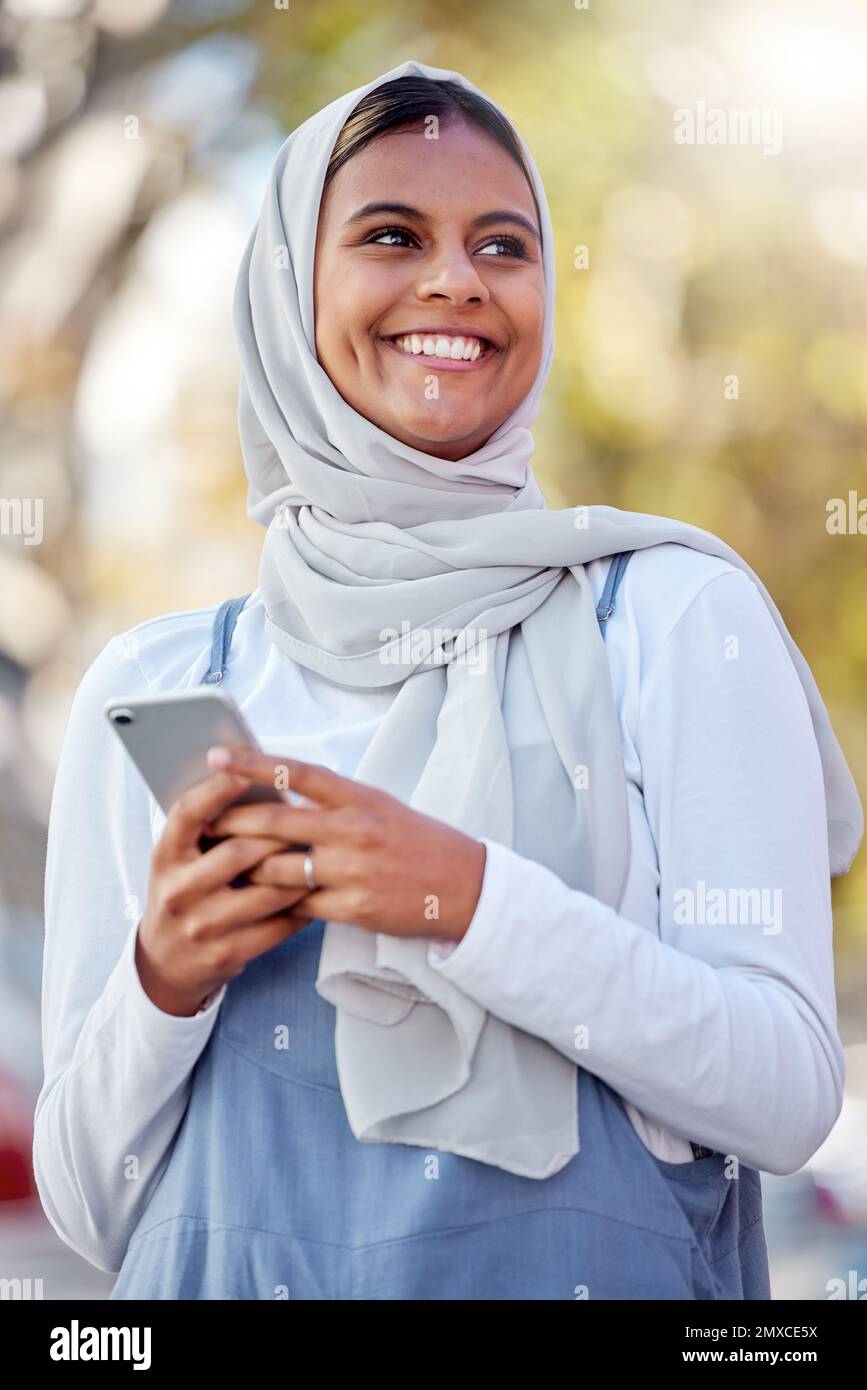 Hijab, phone and thinking of a girl teenager happy outdoor with mobile connection and networking