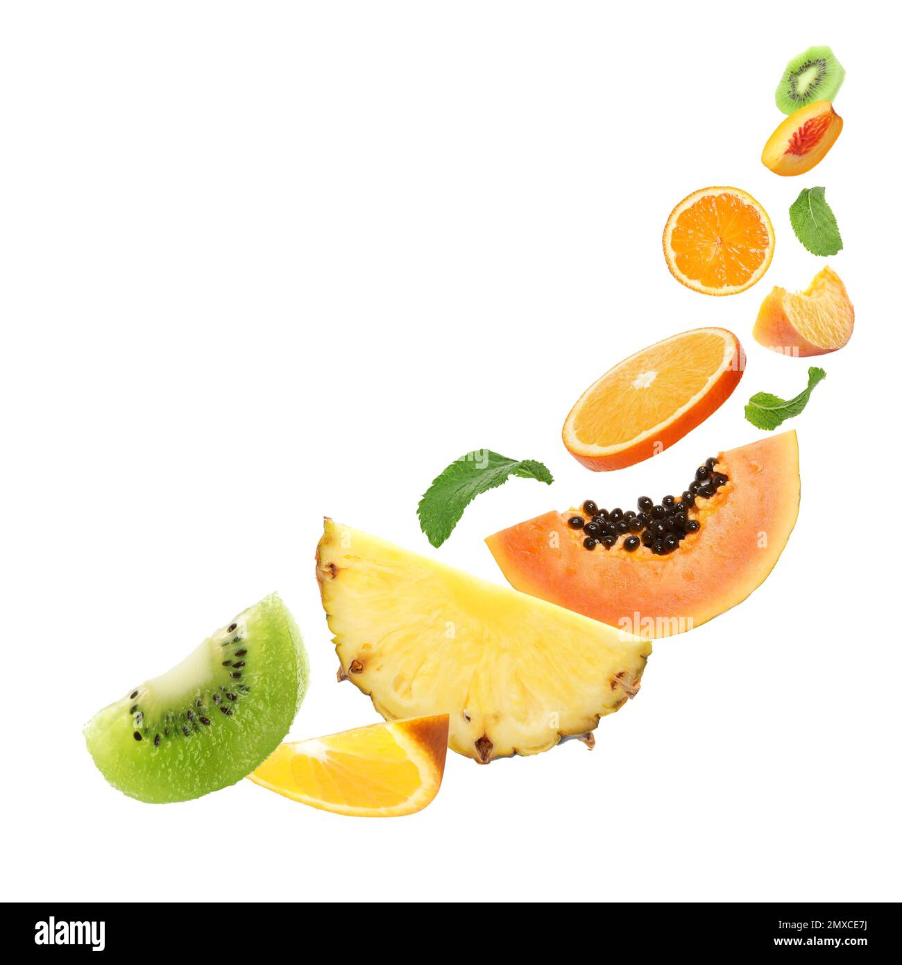 Set of different cut fresh fruits and berries falling on white