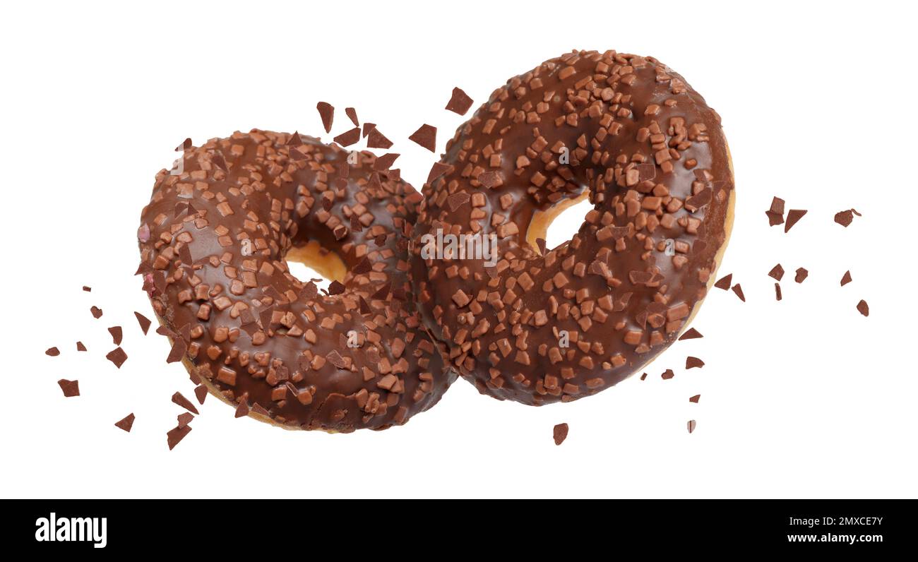 Sweet delicious donuts falling on white background Stock Photo - Alamy
