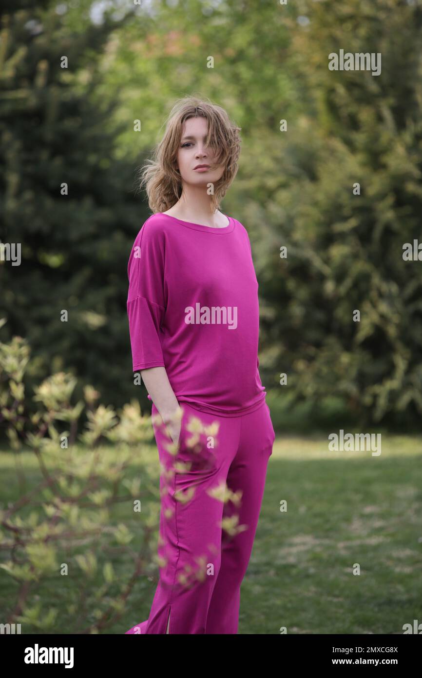 Summer Female Model Outdoor portrait of female model in bright pink outfit enjoying in ...