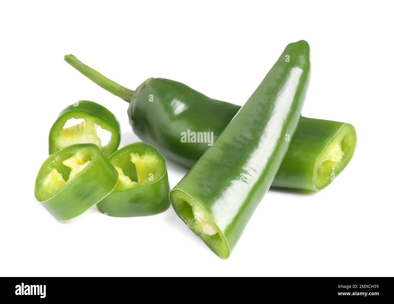 Cut green hot chili peppers on white background Stock Photo - Alamy
