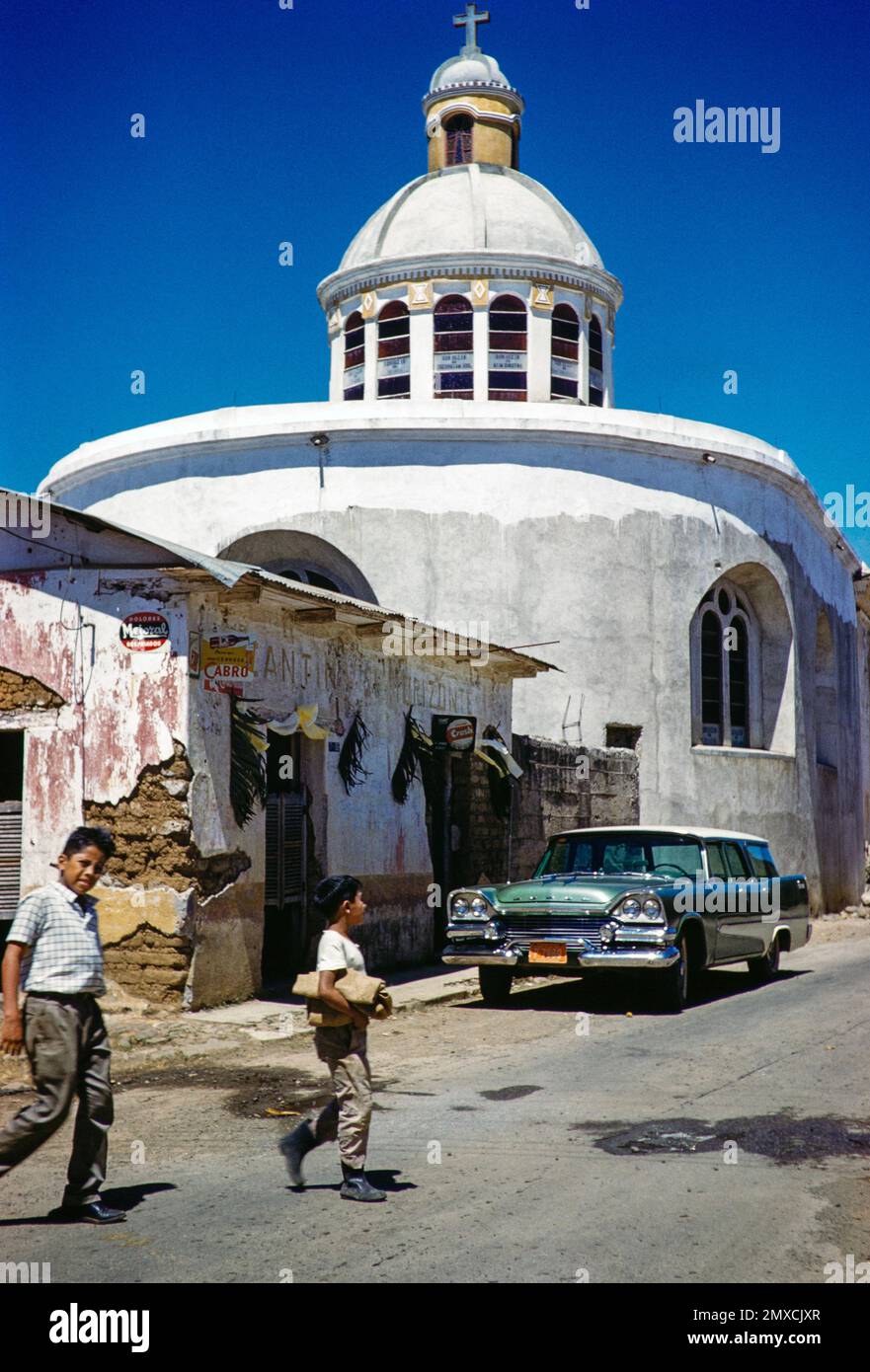 Village church after completion of top of dome,  Palin, Guatemala, Central America, c 1961 American 1958 Dodge Kingsway station wagon car Stock Photo