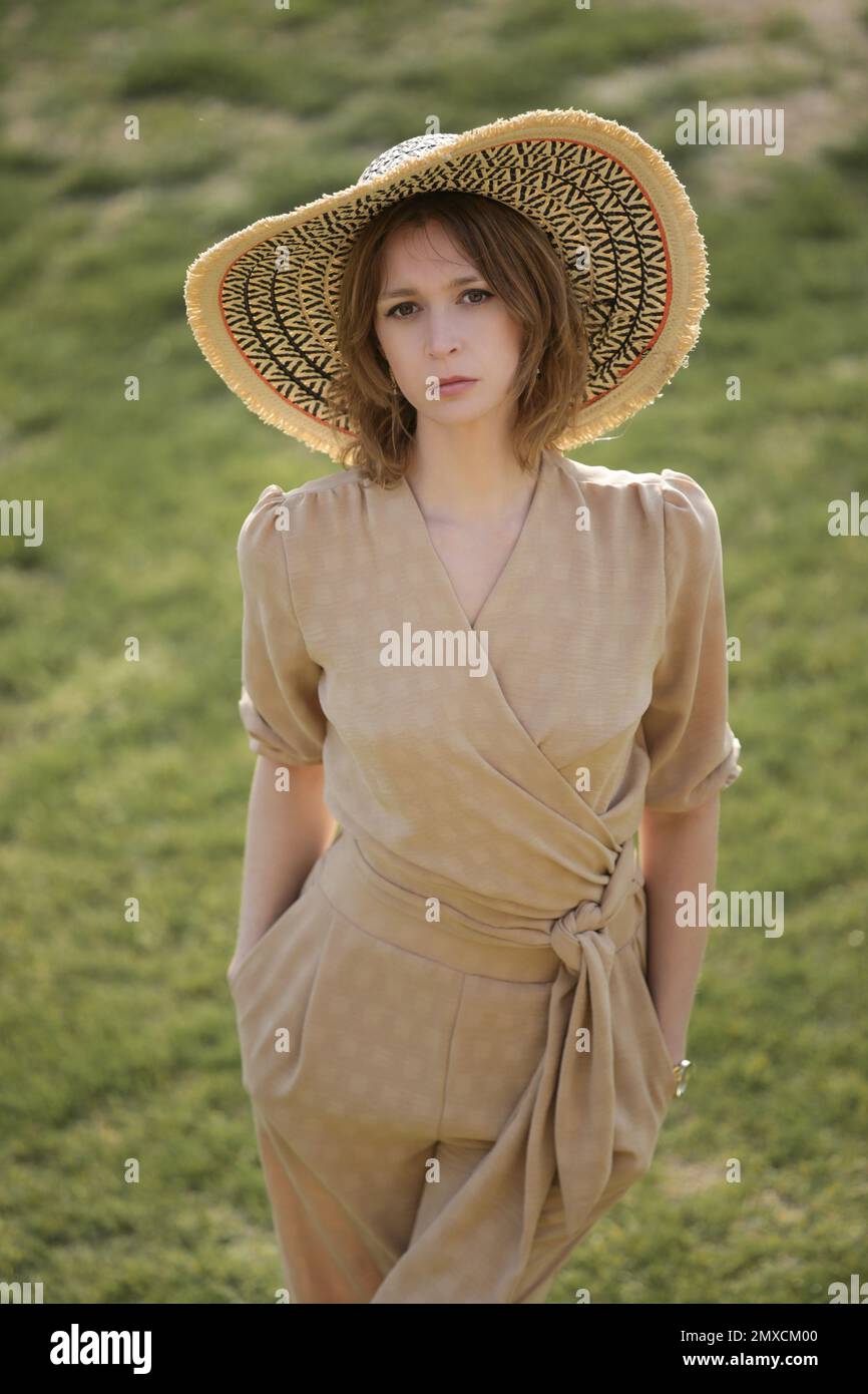 Summer Female Model Outdoor portrait of female model in beige linen outfit enjoying a ...