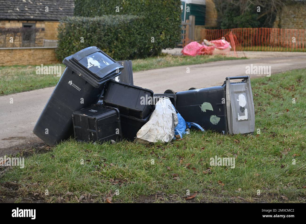 Empty wheelie bins lying on their side following rubbish collection in