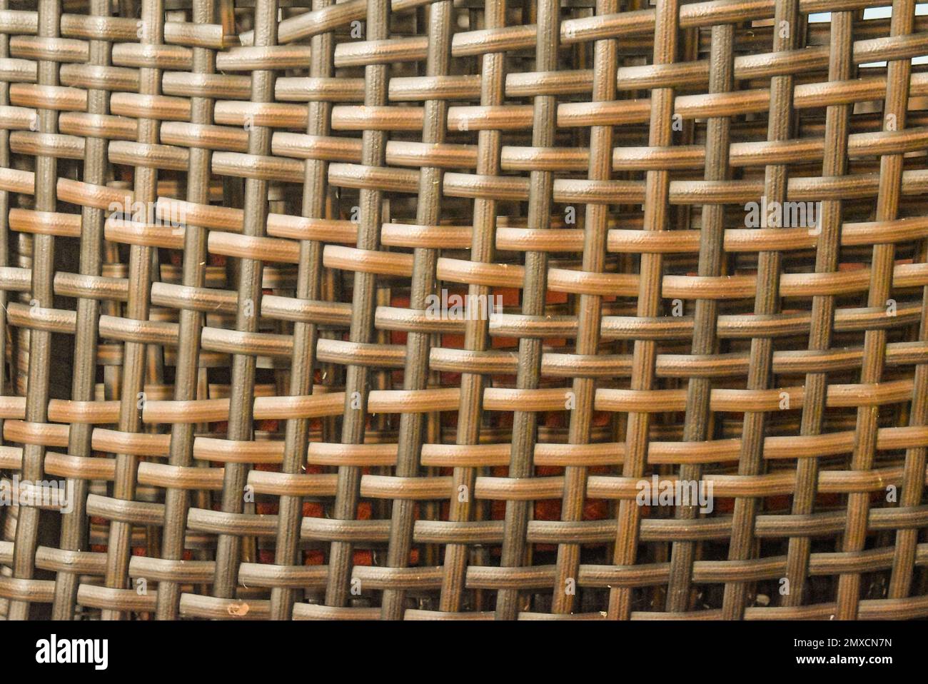 A closeup view of a of dry straw woven with giant rib with large holes ...