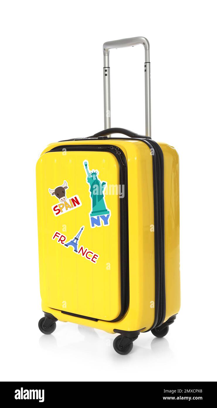 Modern suitcase with travel stickers on white background Stock Photo