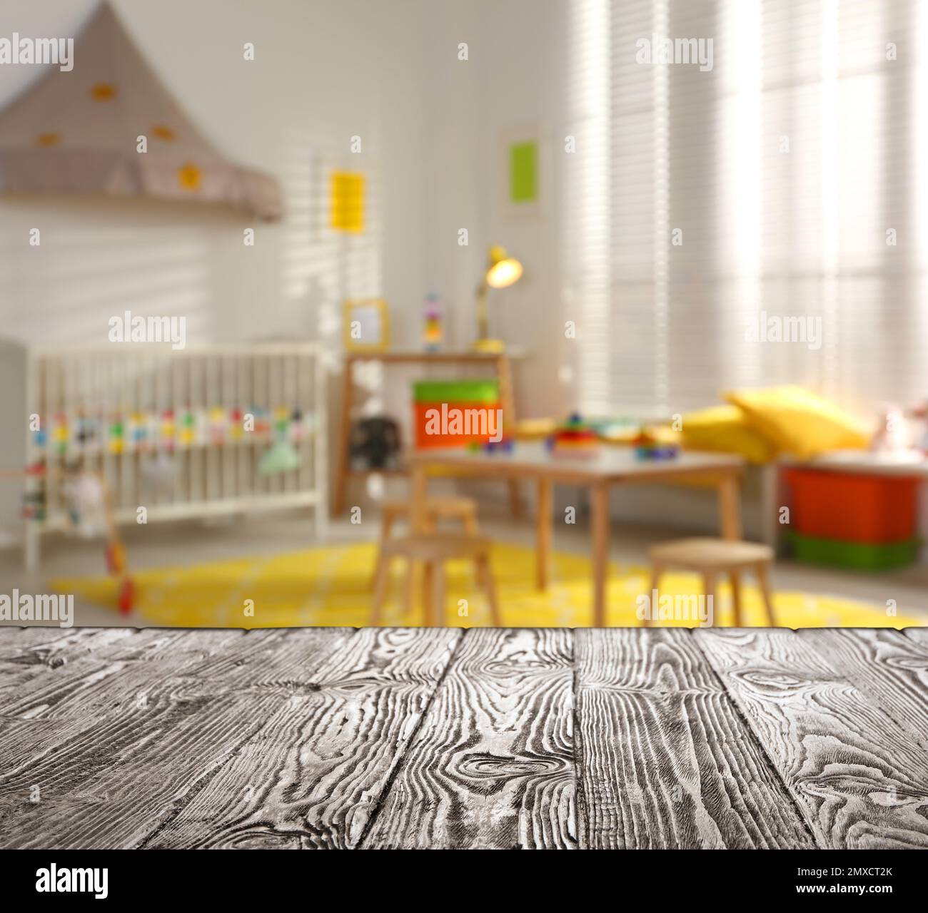 Empty wooden table in baby room interior Stock Photo - Alamy
