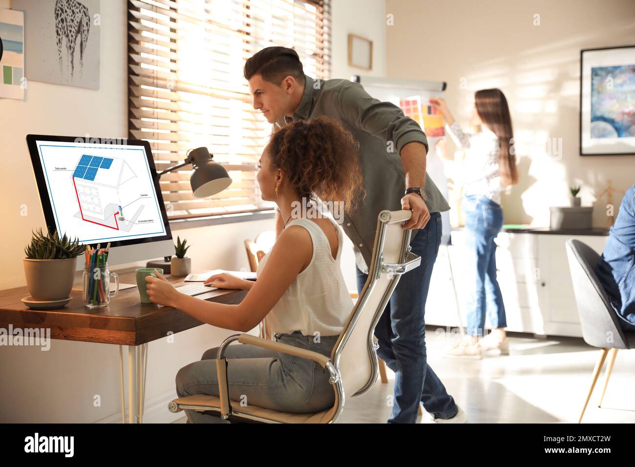 Engineers at work. Colleagues projecting house in office Stock Photo