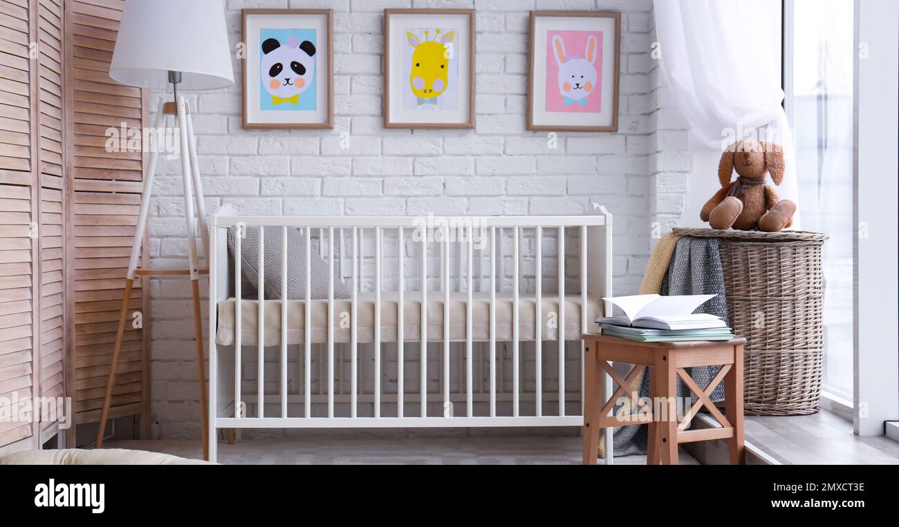 Baby room interior with comfortable crib. Banner design Stock Photo - Alamy