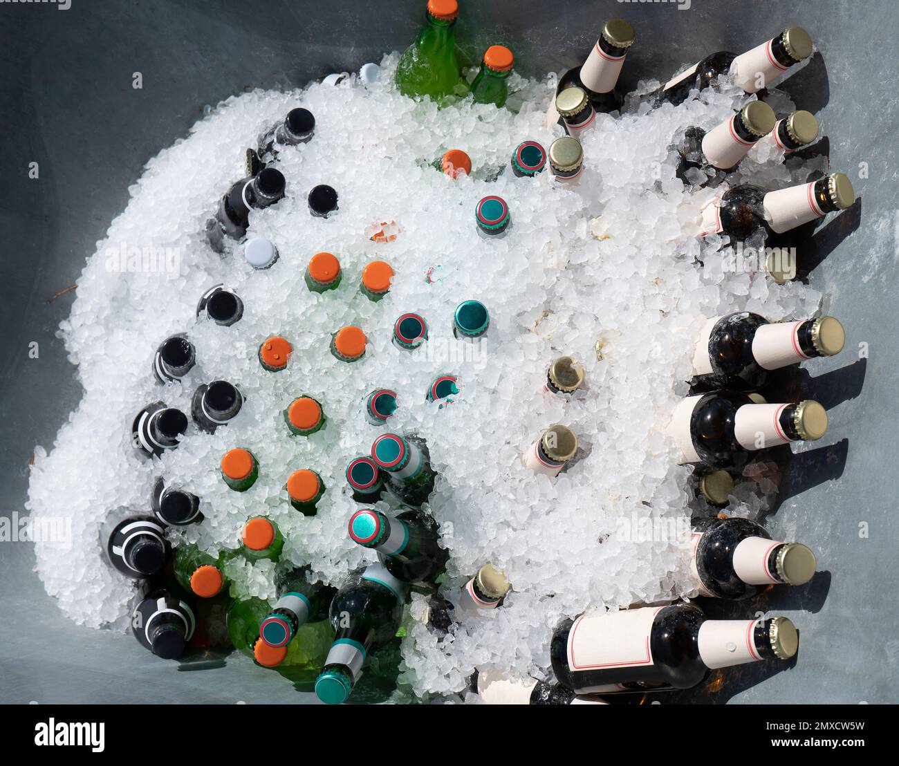 Various bottled drinks in a container filled with crushed ice seen from above Stock Photo