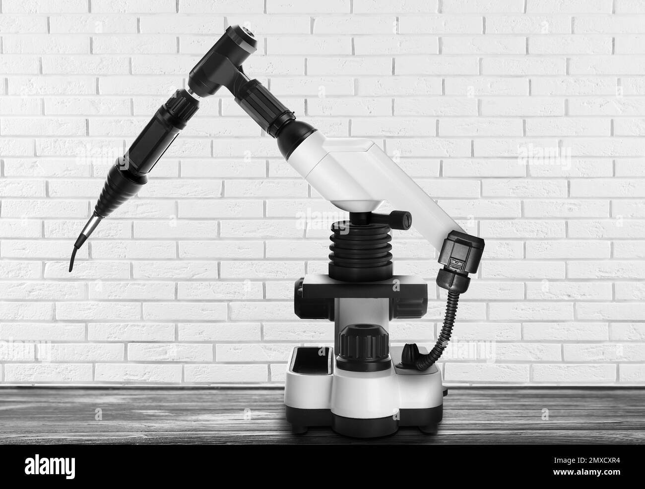 Modern electronic laboratory robot manipulator on wooden table indoors. Machine learning Stock Photo