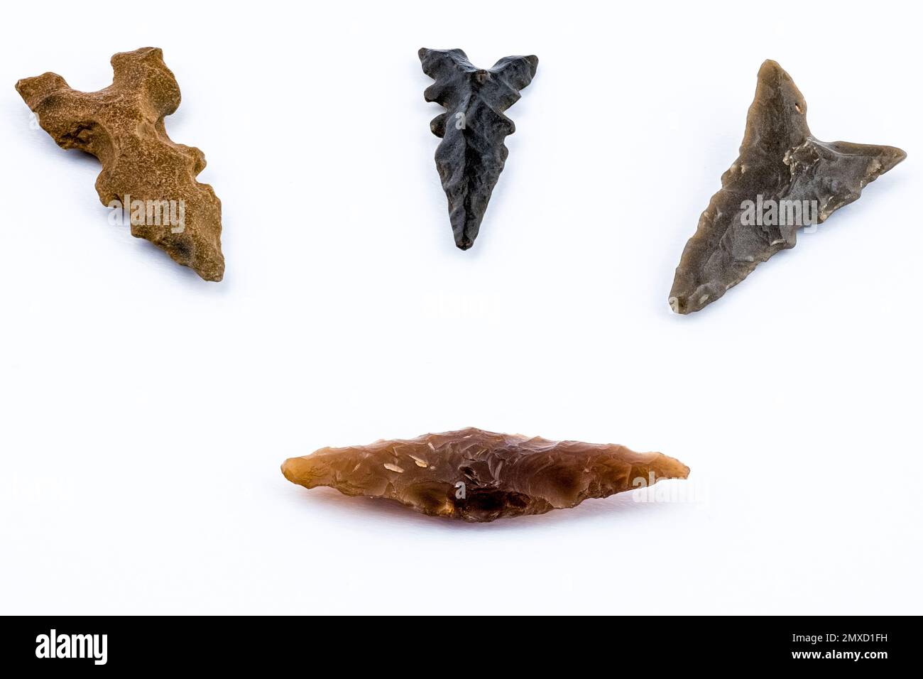 Close up of four arrowheads from the Nude Stone Age. High depth of focus Stock Photo