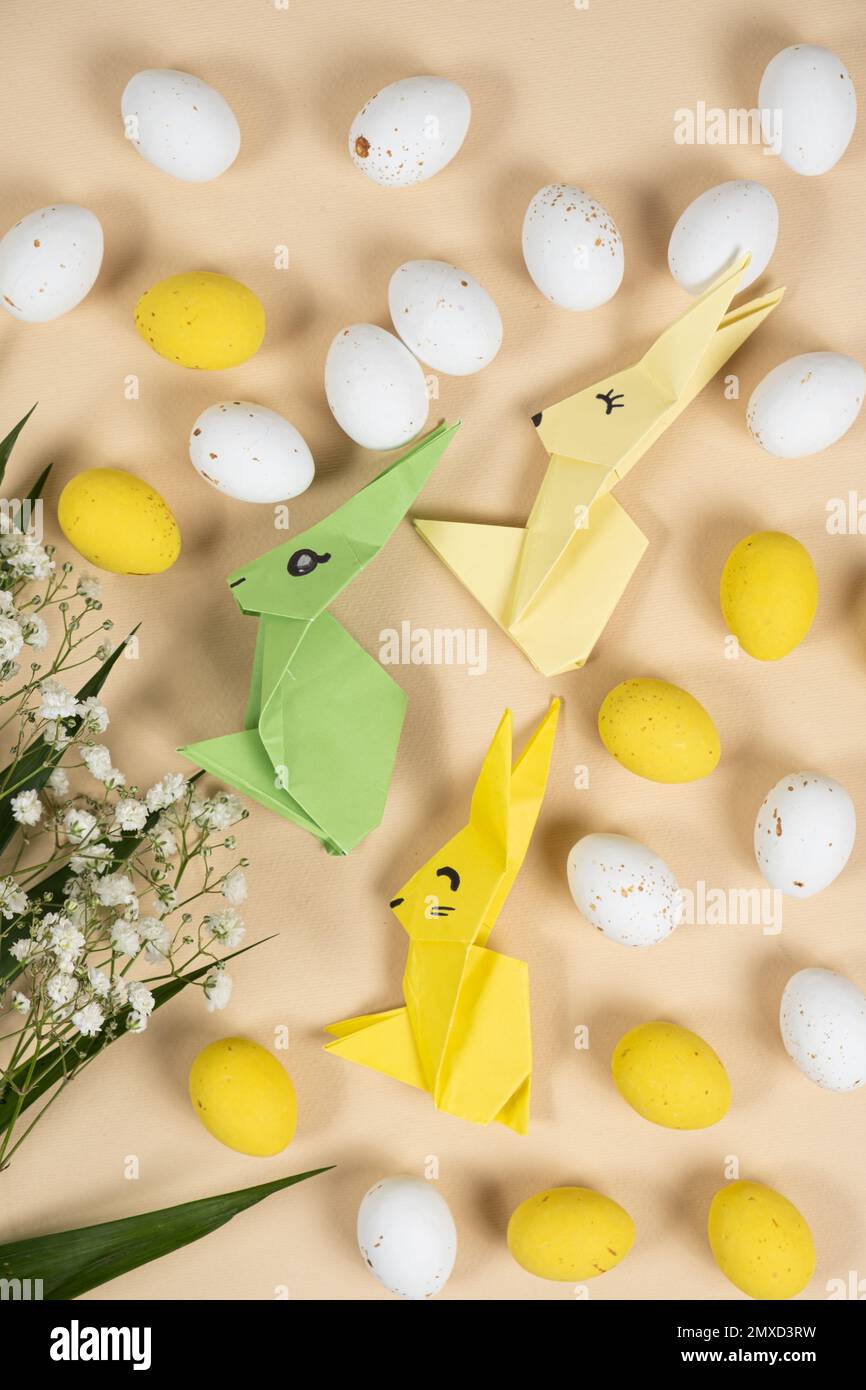 Happy Easter bunnies made of origami paper, eggs and flowers, top
