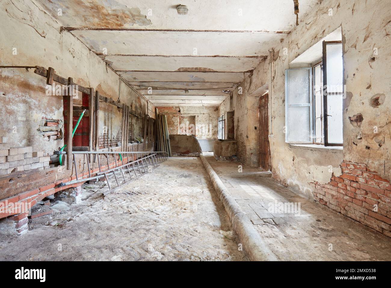 Old cattle shed with damaged walls in country house in Italy Stock Photo