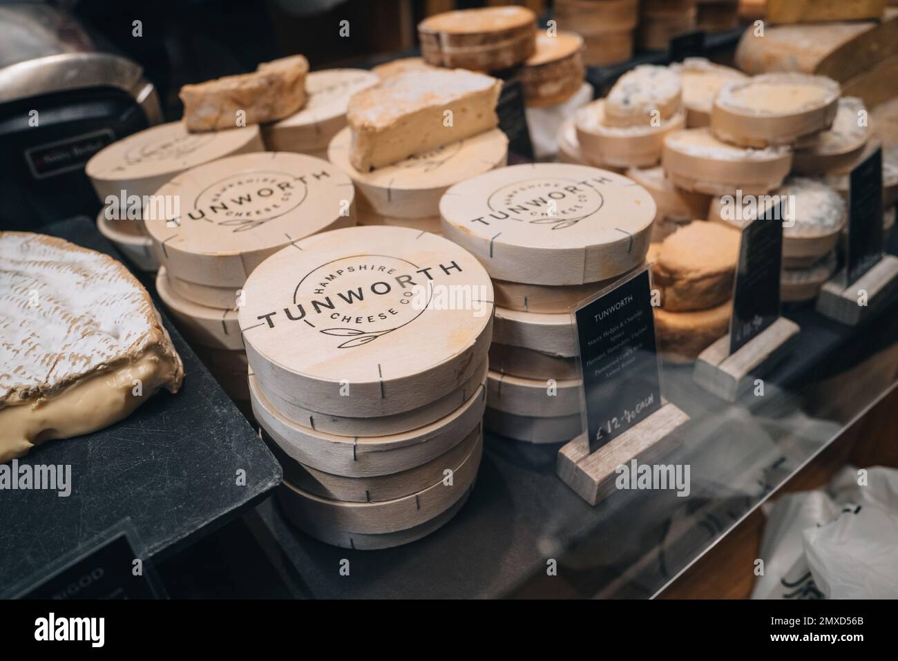 London, UK - January 27, 2023: Tunworth Cheese Co cheese on sale at Neal's Yard Dairy stall inside Borough Market, one of the largest and oldest food Stock Photo