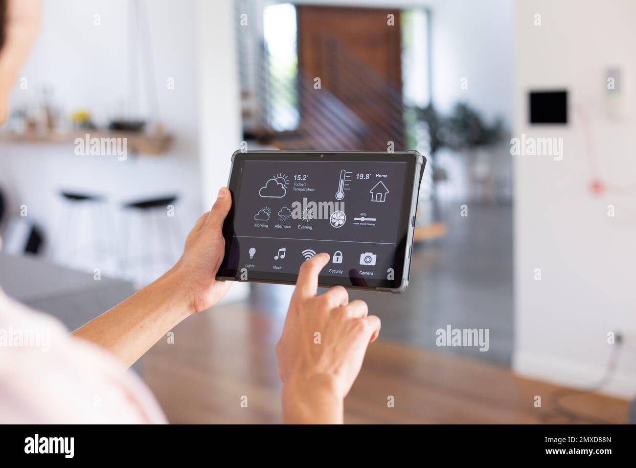 Hands of biracial man at home using tablet with smart home interface on ...