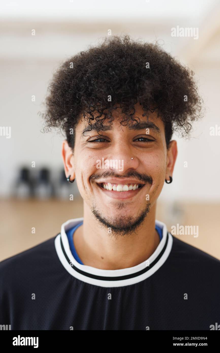 Vertical portrait of biracial man with curly hair in kitchen at home Stock  Photo - Alamy