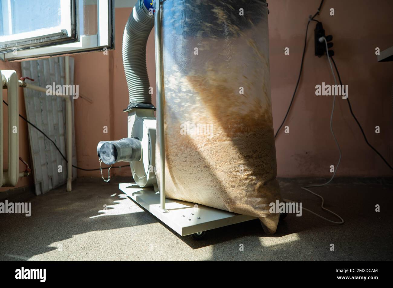 Vacuuming sawdust while sawing wood. Chip blower in furniture