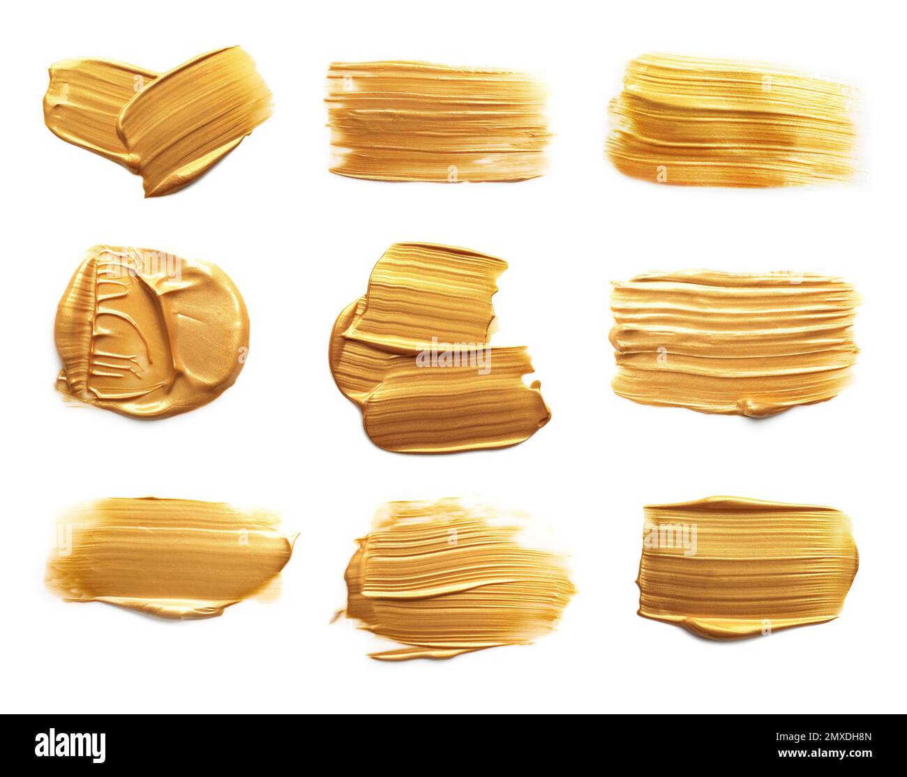 Set with strokes of gold paint on white background, top view Stock Photo