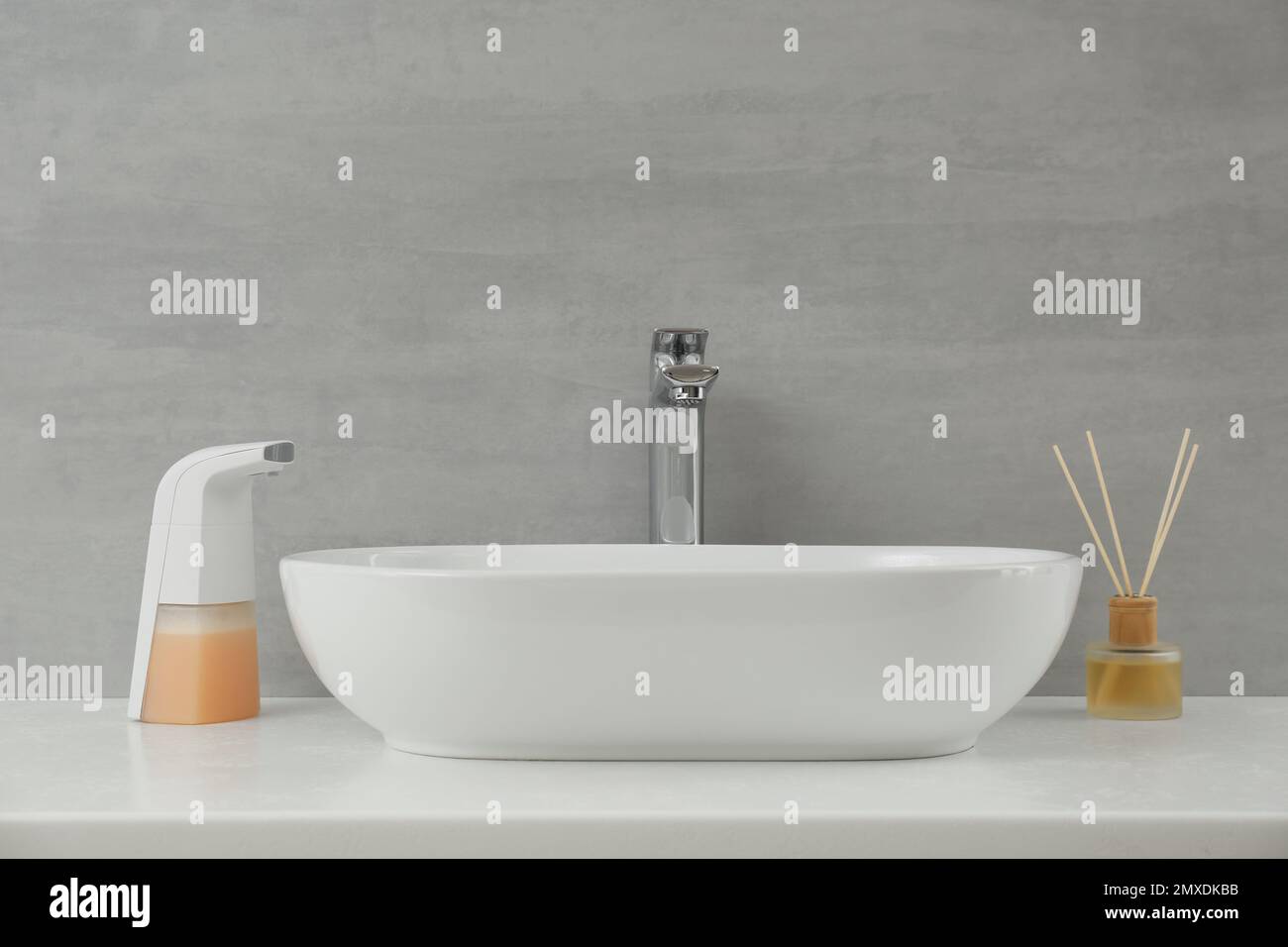 Modern automatic soap dispenser near sink in bathroom Stock Photo - Alamy
