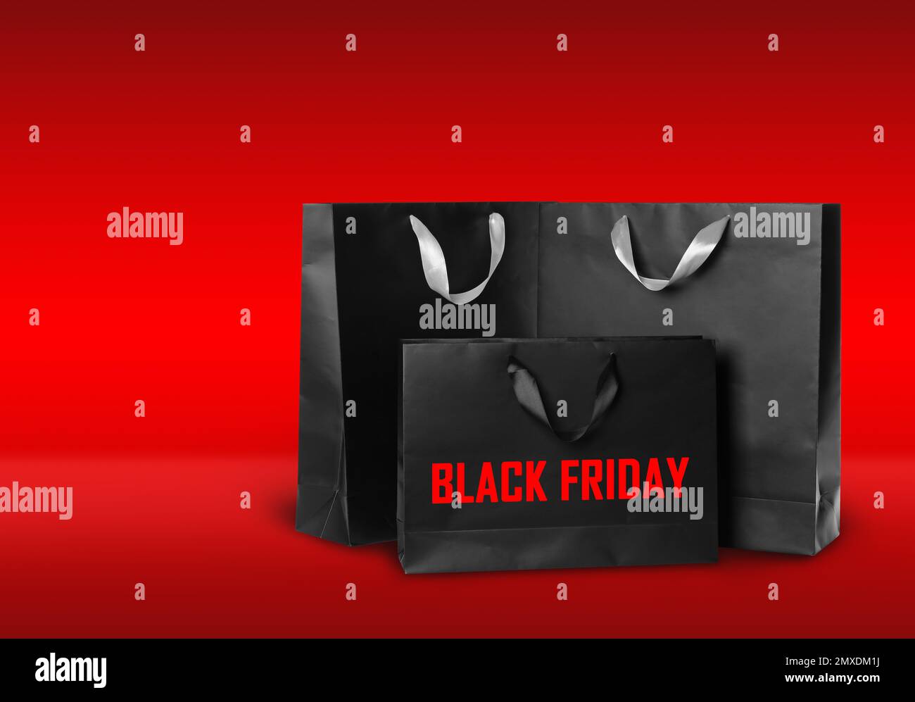 Paper shopping bags on red background. Black friday Stock Photo
