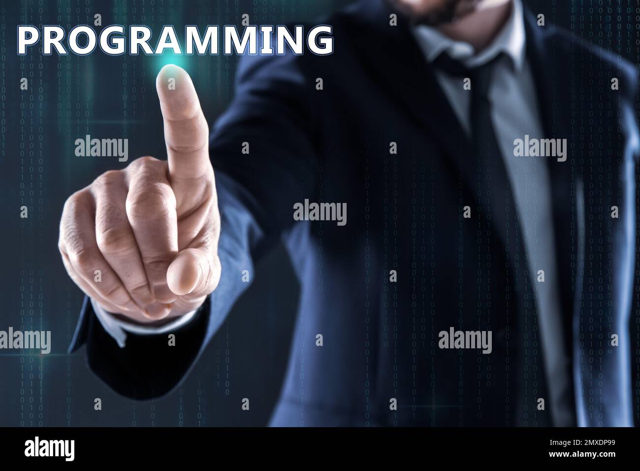 Businessman pointing at word PROGRAMMING on virtual screen, closeup Stock Photo