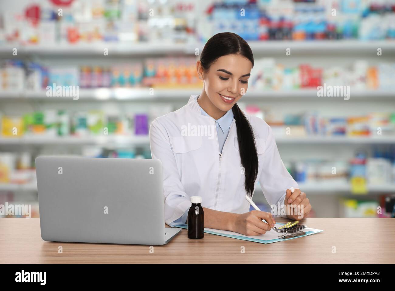 Blurred view female pharmacist hi-res stock photography and images - Alamy