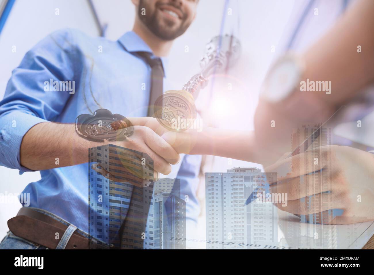 Multiple exposure of man with documents, cityscape and business partners shaking hands, closeup Stock Photo
