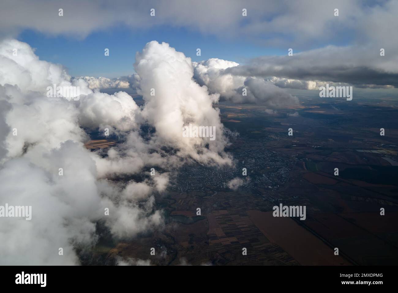 Aerial view at high altitude of earth covered with puffy cumulus clouds ...