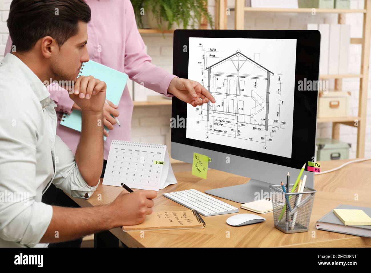 Architects making project of house on computer in office Stock Photo ...