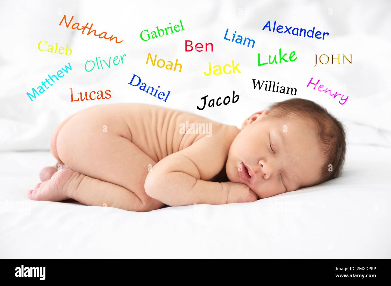 Choosing name for baby boy. Adorable newborn sleeping on bed Stock Photo Alamy