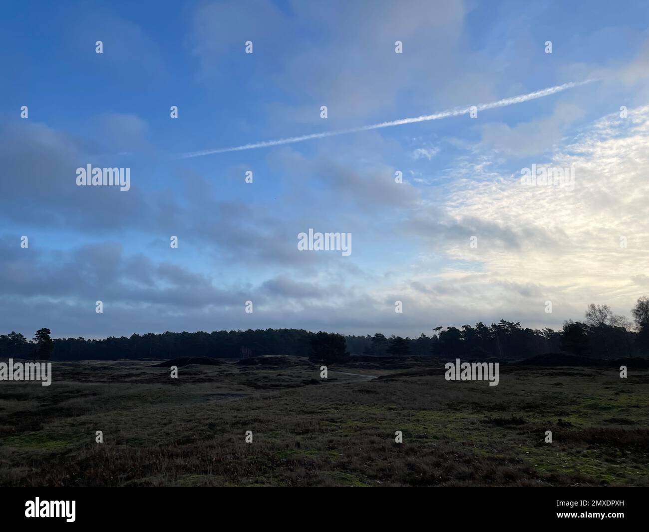 The cloudy sky over a countryside field Stock Photo - Alamy