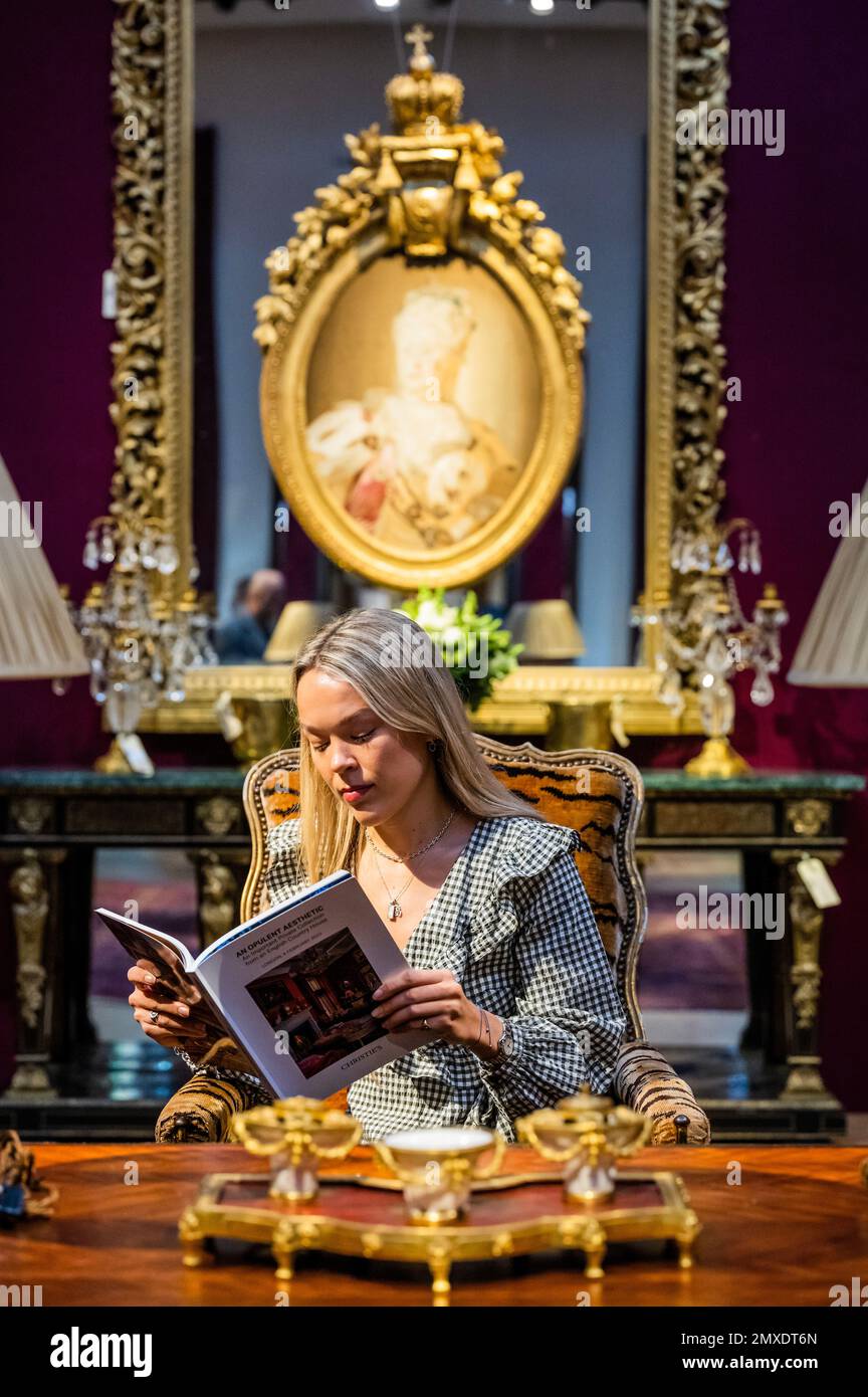 London, UK. 3 Feb 2023. A member of staff sits on a Regence Giltwood Reclining Fauteuil, Circa 1715, Estimate GBP 20,000 - GBP 30,000 amongst other items - A preview of An Opulent Aesthetic: An Important Private Collection from an English Country House, at Christies, which will be auctioned on February 9. The sale comprises 266 lots spanning 19thcentury and Old Master paintings, fine furniture, clocks, porcelain, silver, soft-furnishings and lighting. Some works come from the collections of Alberto Bruni Tedeschi, the Lords Hesketh at Easton Neston and the Sackville family at Knole. Estimates Stock Photo