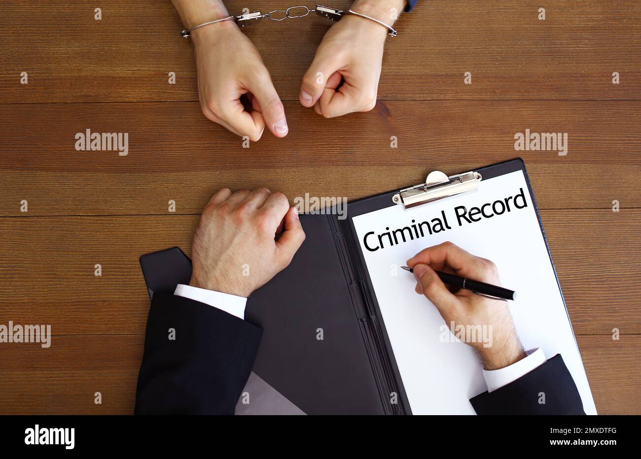 Police officer examining criminal record at desk, top view Stock Photo