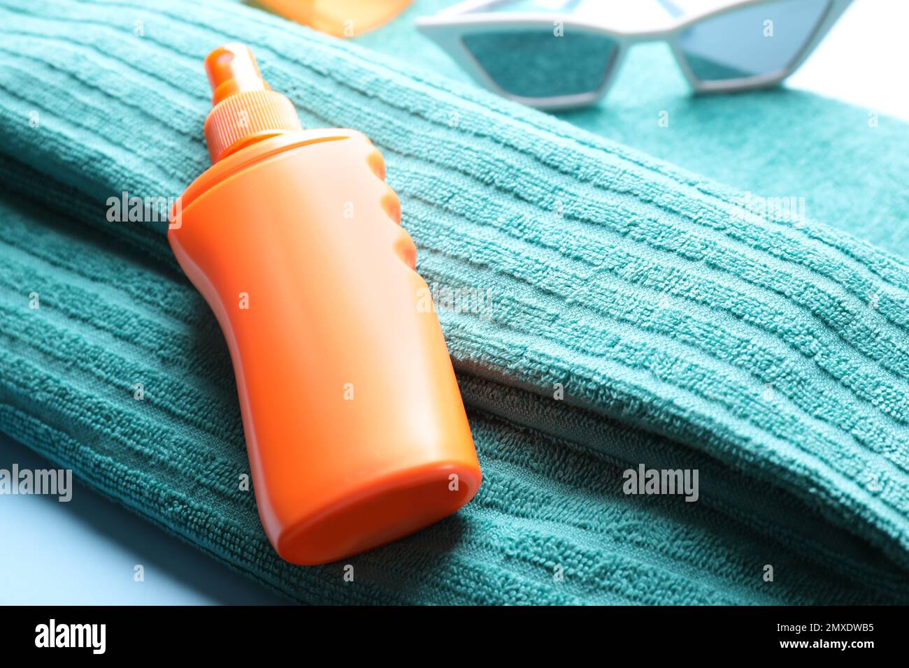 Sun protection spray on towel, closeup view Stock Photo Alamy