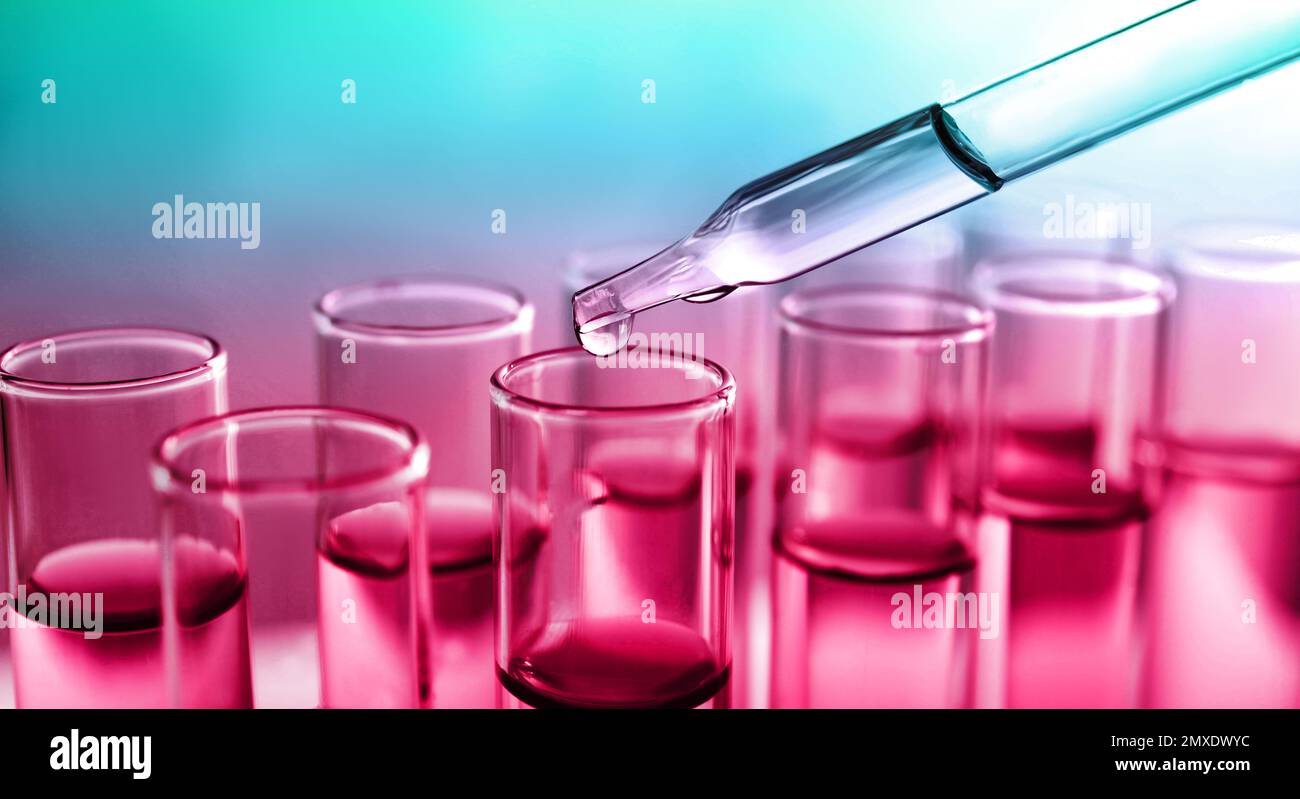Dropping sample into test tube with liquid on color background, banner