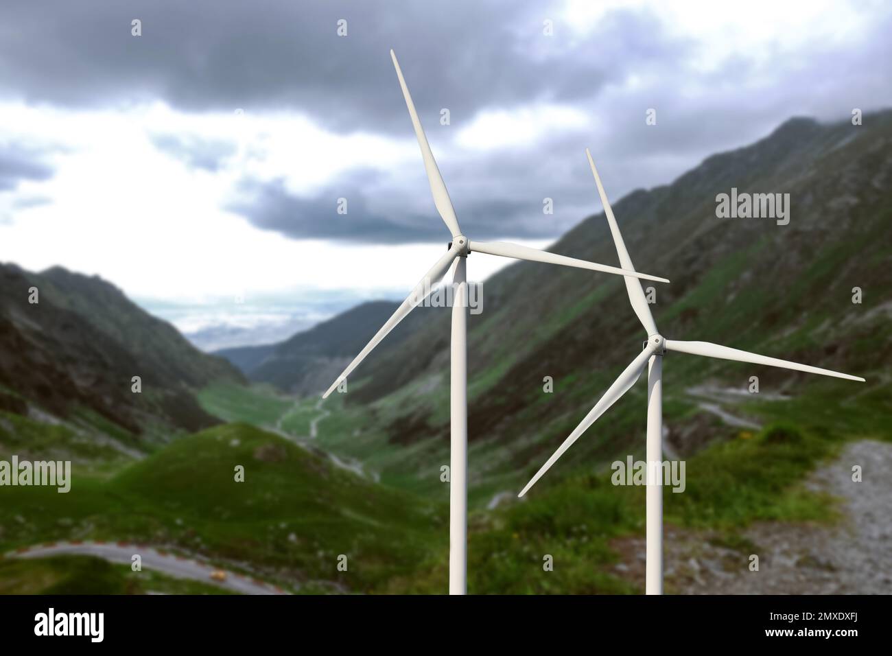 Alternative energy source. Wind turbines and mountains outdoors Stock Photo