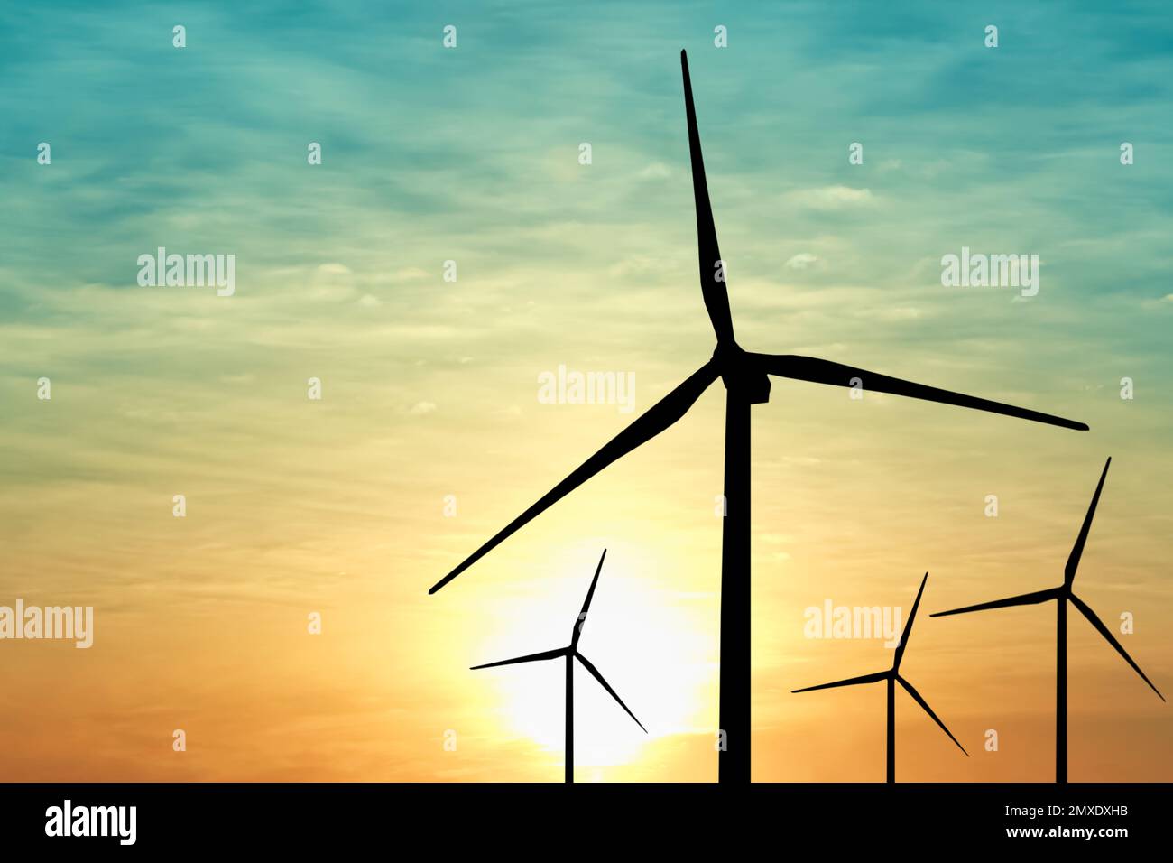 Silhouettes of wind turbines at sunset. Alternative energy source Stock ...