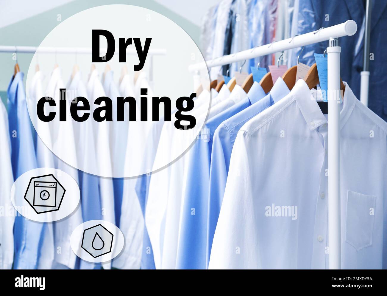 Rack with clean clothes on hangers after drycleaning indoors Stock