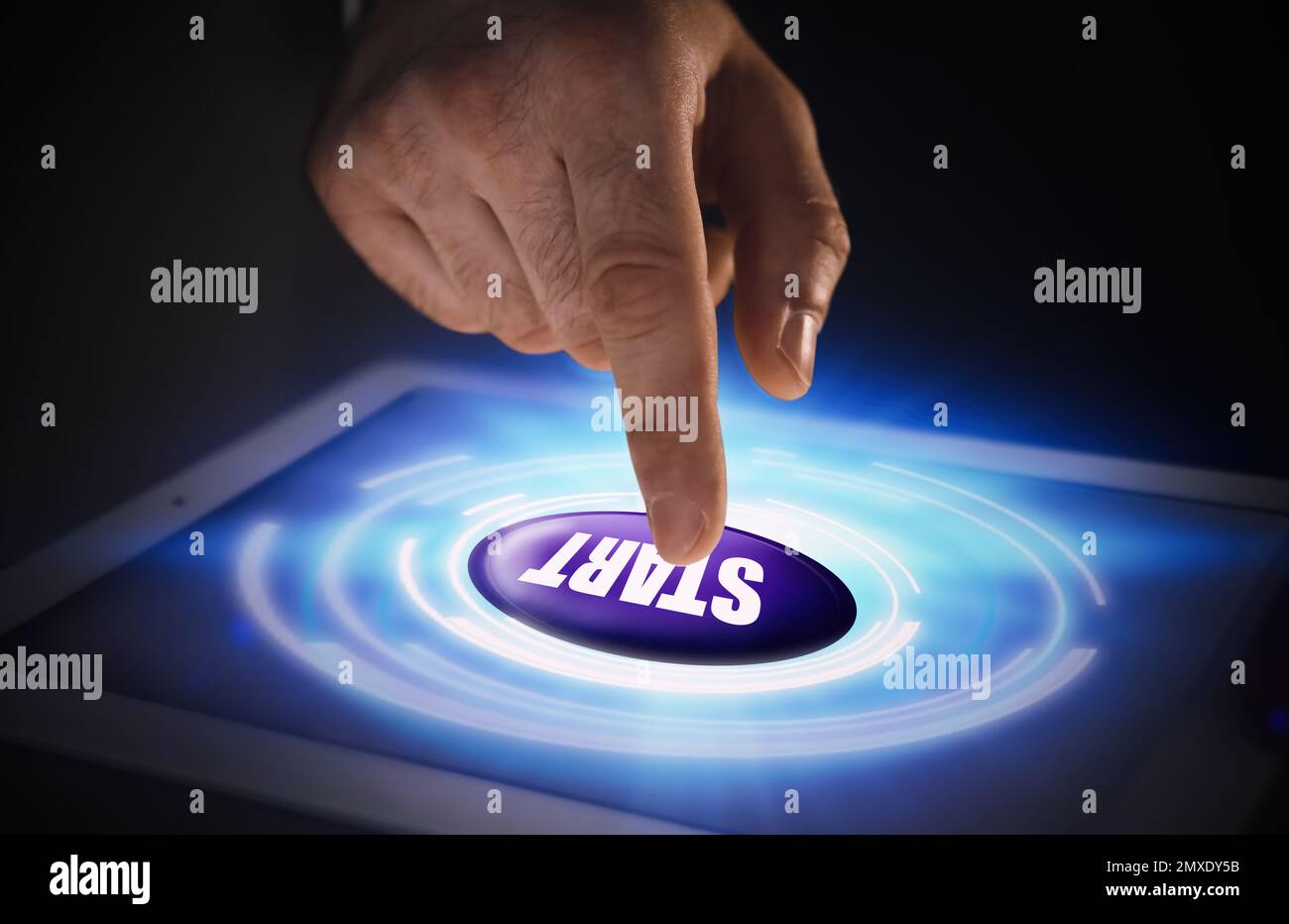 Man pointing at start icon on tablet, closeup Stock Photo
