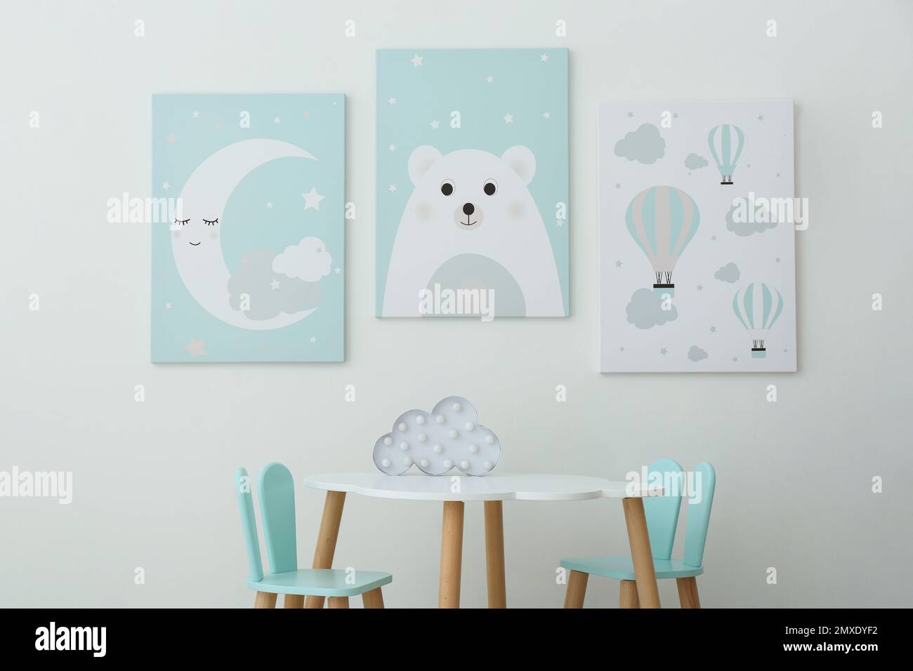 Adorable wall art, table and chairs with bunny ears in children's room interior Stock Photo Alamy