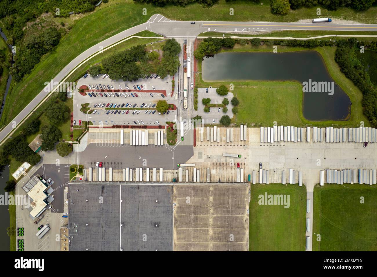 Aerial view of large commercial distribution center with many trucks ...