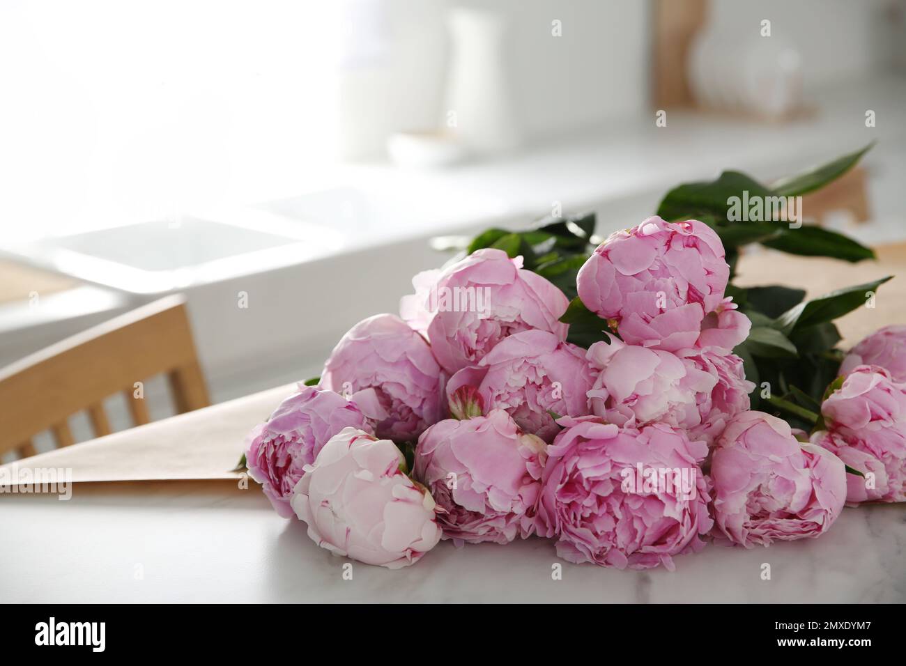 Bouquet of beautiful pink peonies on table in kitchen Stock Photo - Alamy